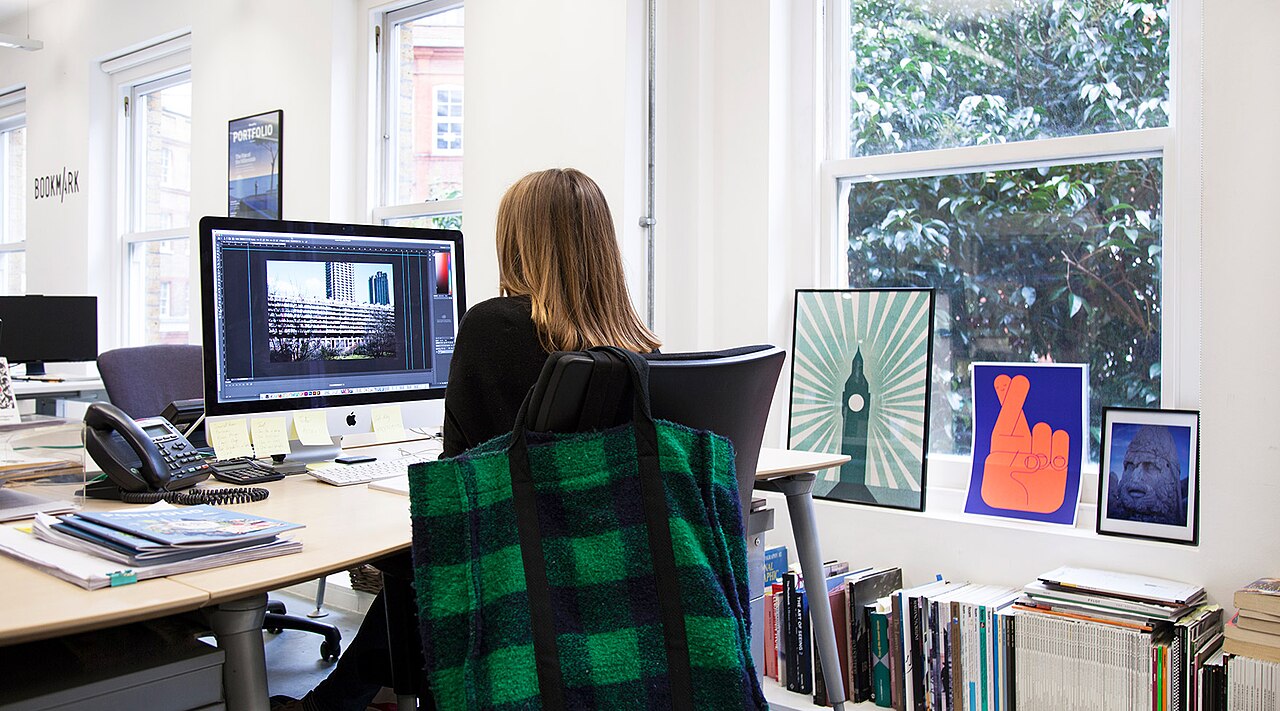 An employee sitting at a desk, focused on working at a computer