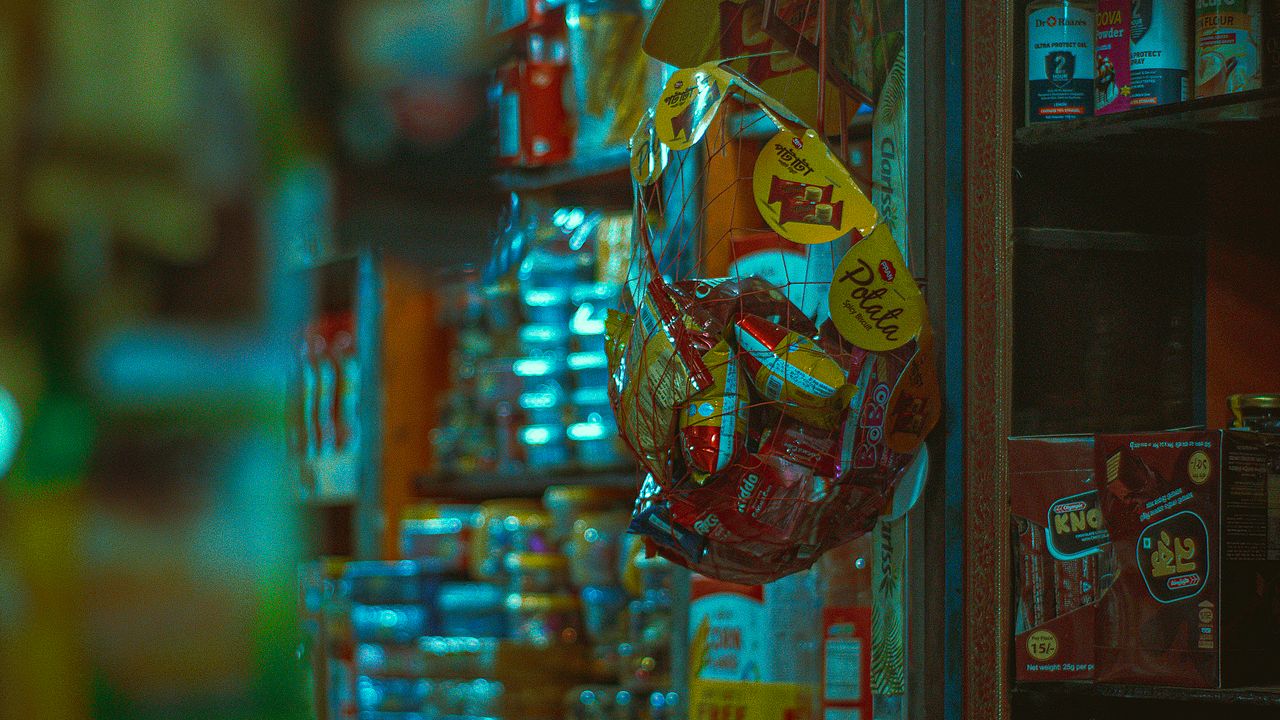 Shelves of snacks and goods inside a small retail shop