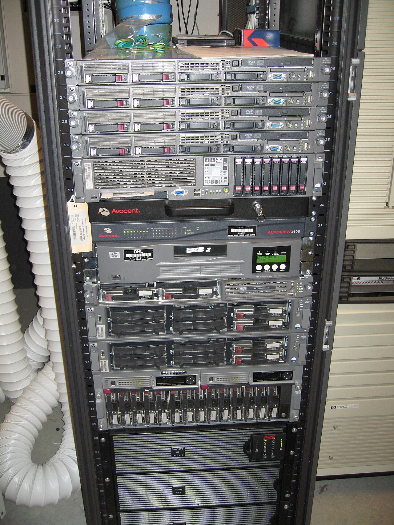 Rows of computer server racks and cables in a data center room