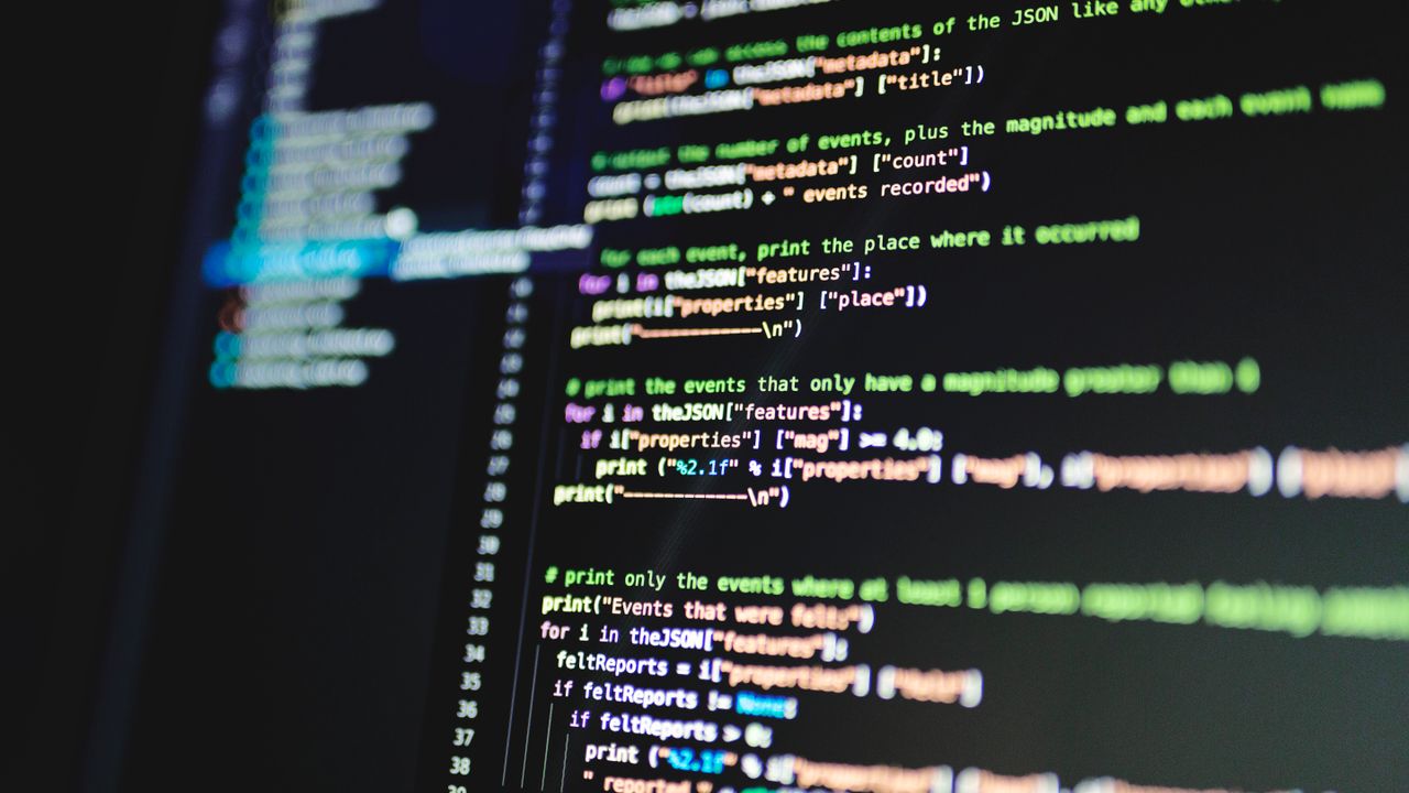Close-up of colorful programming code displayed on a computer monitor with a dark background